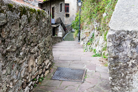 A beautiful street of a small European city of San Vicente de la Barquera in northern Spain,...
