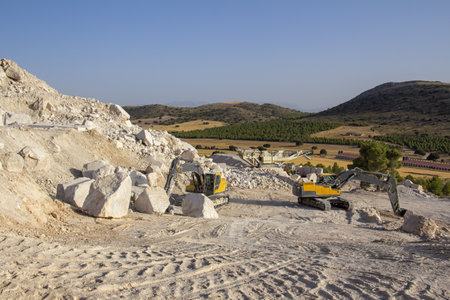 Machinery working at a marble quarry in Andalusia (Spain) with blue sk