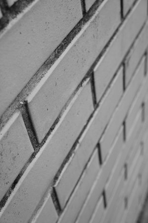 A vertical shot of a brick wall in grayscaleの写真素材
