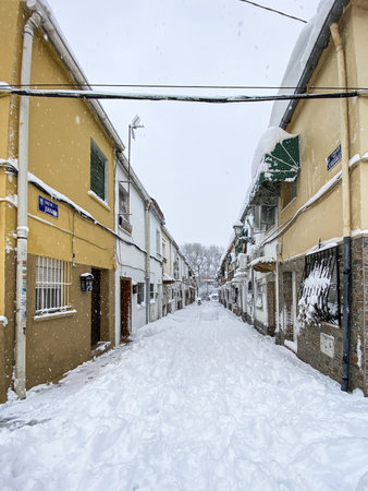 A beautiful shot of an empty urban street after a snowfallの写真素材