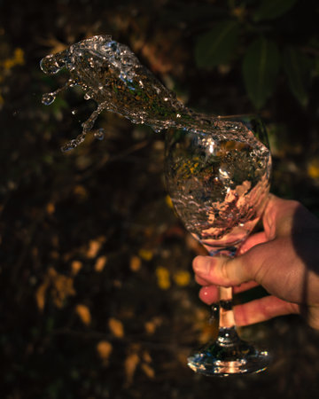 A closeup shot of a person shaking a glass of waterの写真素材