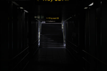 A nice shot of a dark walkway with ssome signsの写真素材