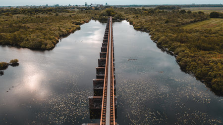 A bird's eye view shot of the Moerputten Bridge over the scenic lakeの写真素材