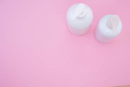 A high angle shot of white plastic bottles on a  backgroundの写真素材