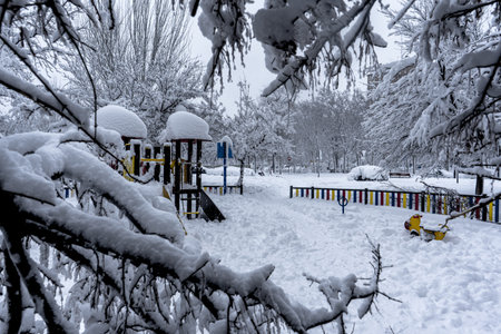 A playground in a snowy urban park in Madrid, Spain in 2021の写真素材