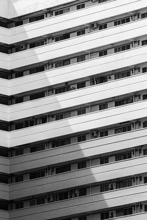 A vertical shot of a modern white building with baの写真素材