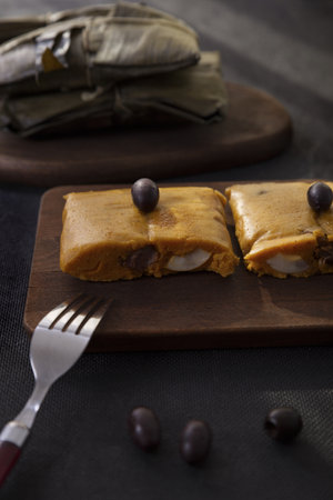 Typical dish of Peru known by the name of tamales, made with corn flour, chicken or pork, garlic,...