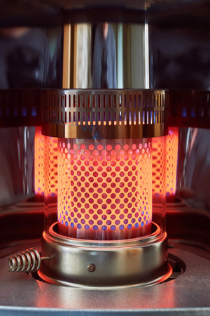 A vertical closeup shot of an incandescent paraffin heater grid