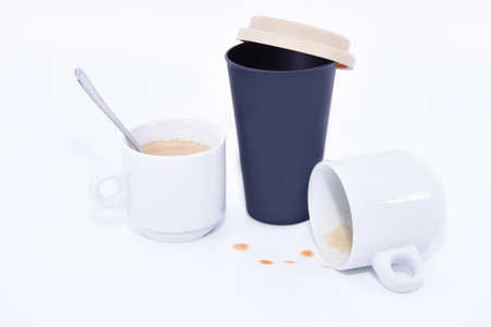 A closeup shot of a paper cup and cups with coffee isolated on white background