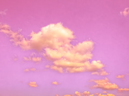 A scenic pink sky with white clouds - perfect for backgroundの写真素材