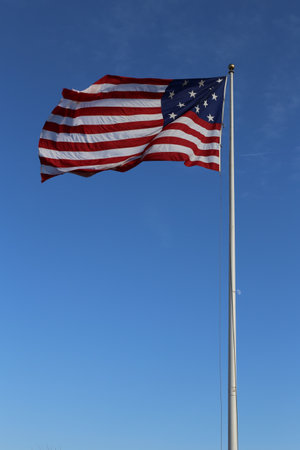 A vertical shot of the USA flag on a blue background
