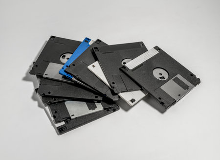 A closeup shot of various old floppy disks on white background