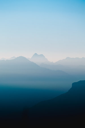 A vertical shot of mountains in the cloudsの写真素材