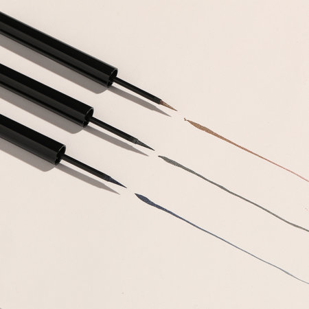 A closeup shot of eyeliners on whiteの写真素材