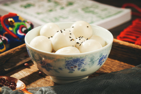 A closeup of a bowl of glutinous rice balls on the table in a Chinese restaurantの写真素材