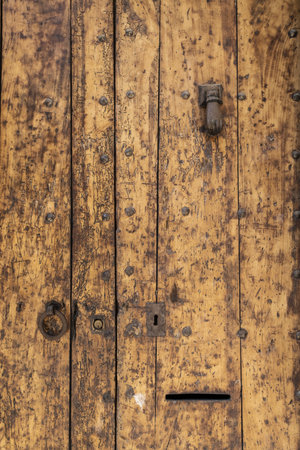 a vertical shot of an old brown door with scratches and spotの写真素材
