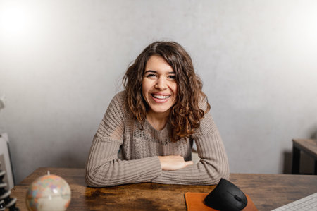 A young cheerful Caucasian female social media influencer filming a casual video blog with positive vibesの写真素材