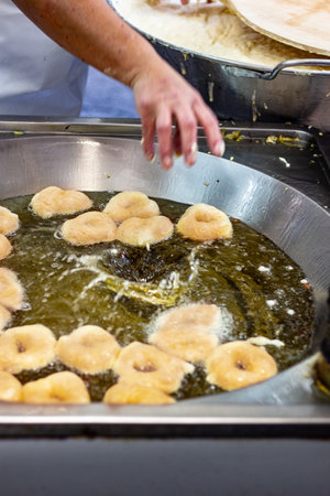A closeup shot of the process of making doughnut or donuts
