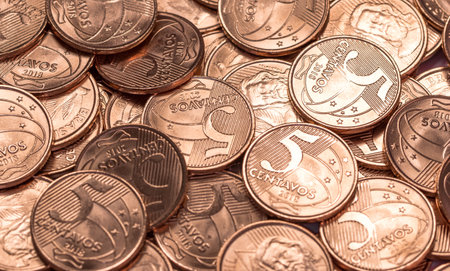 A top view of a pile of shiny Brazilian coins