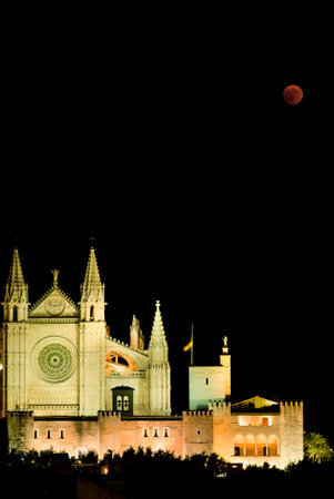 A vertical shot of the Lunar Eclipse over the Cathedral in Palma de Mallorca, Spainの写真素材
