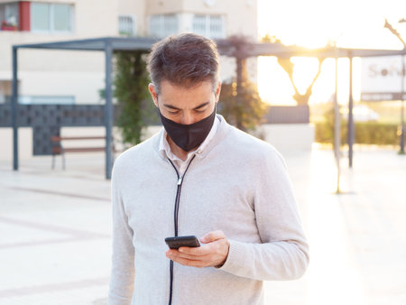 A closeup of  stylish Caucasian businessman giving a business consultation on his phoneの写真素材