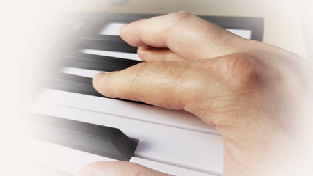 A closeup shot of a pianist's hand playing the piano