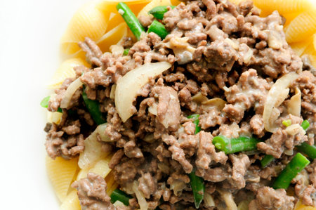 hamburger stroganoff with green beans over shell pastaの写真素材