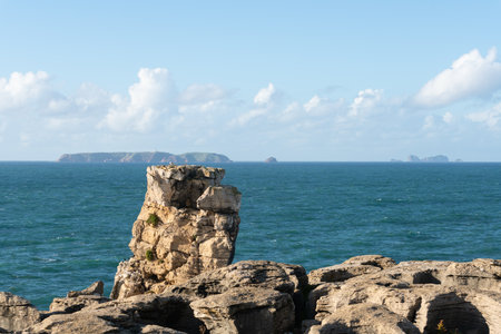 Peniche sea cliffs with Berlengas Island on the background with atlantic ocean, in Portugal