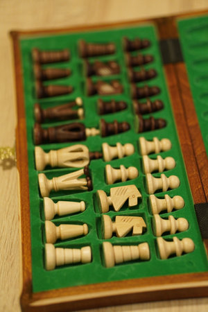 A selective focus shot of chess figures in a green velvet case