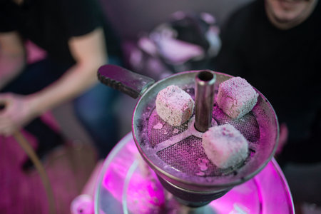 A high angle shot of burning charcoal of a hookah in a barの写真素材