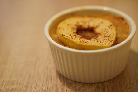 A selective focus shot of delicious homemade apple and rice pudding in a baking moldの写真素材