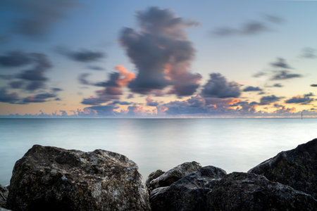 A beautiful view of dynamic red colored clouds above the Dutch lake IJsselmeer near the Stavoren town, Friesland, Netherlandsの写真素材