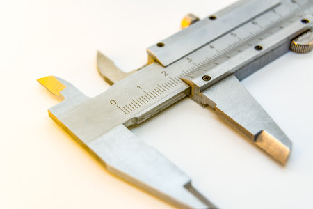 A closeup shot of a caliper on a white background