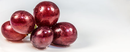 A panoramic shot of fresh grapes on a white backgroundの写真素材