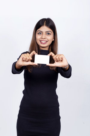 An Indian businesswoman showing a blank card and smiling happilyの写真素材