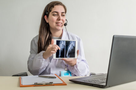 A shallow focus of healthcare consult showing the X-RAY of bones during an online consultation