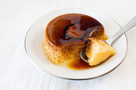 A closeup shot of homemade custard pudding on a white plate