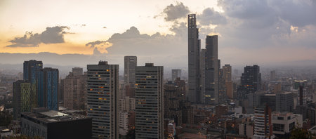 The skyline of modern buildings in Bogota, Columbia during sunsetの写真素材