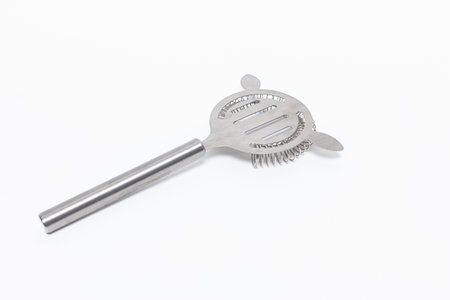 A closeup shot of a stainless steel cocktail strainer isolated on a white background