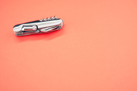 An isolated shot of the multifunctional pocket knives on a pink backgroundの写真素材
