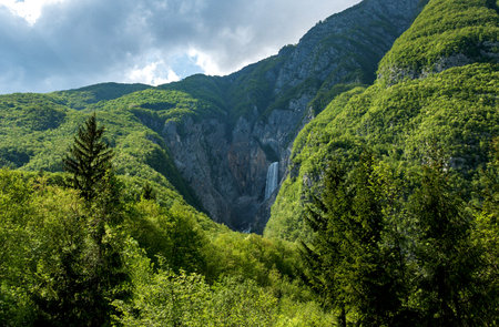 Beautiful scenery with waterfall, hills, mountains and forest. Spring, summer, lush forest greenery, green, nature, beauty in nature, outdoors.の写真素材