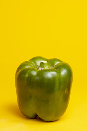 White space around contrasting green reflecting peel of a paprika or bell pepper.の写真素材