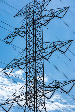 A silhouette shot of the transmission tower against a blue skyの写真素材
