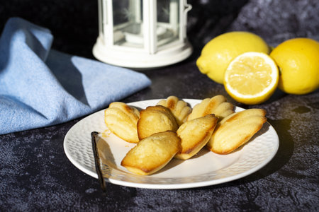 A closeup shot of shell-shaped muffins on a white plate in the kitchenの写真素材