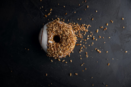 A top view of a glazed sweet donut with nuts