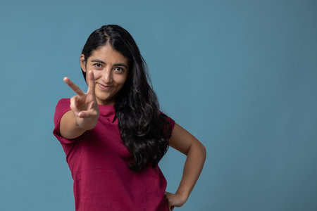 A Mexican female gesturing the peace signの写真素材