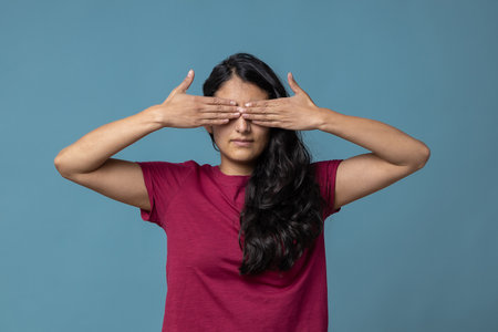 A Mexican female covering her eyes as censorship conceptの写真素材