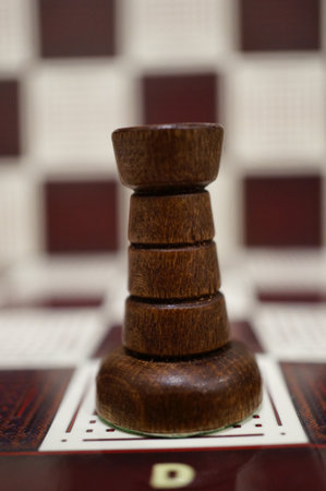 A vertical and close-up shot of a black Rook on the chess boardの写真素材