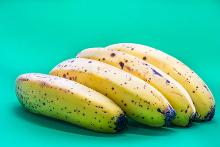 A closeup shot of ripe bananas with dark spots onの写真素材