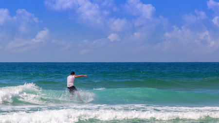 A surfer on beautiful sea waves on a sunny dayの写真素材